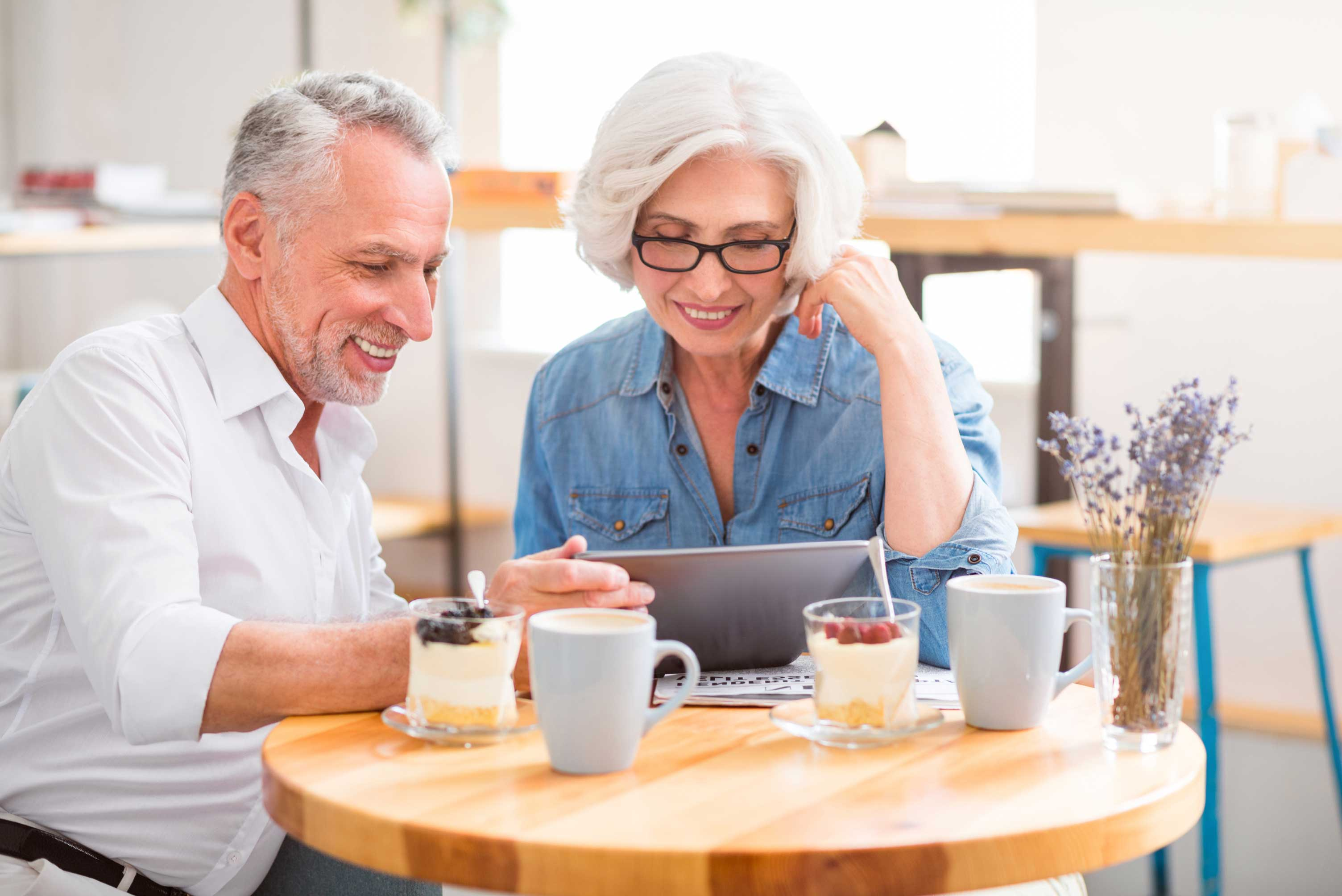 Man and woman looking at a laptop while sitting on the couch, learning about the Seco Program.